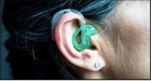 Incorrectly placed hearing aid sticking out of ear and not tucked in properly