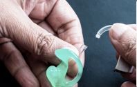 Detaching ear mould from hearing aid carefully