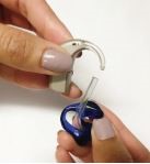 Detaching ear mould from the transparent hook part of the hearing aid
