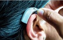 Example of placing hearing aid behind ear