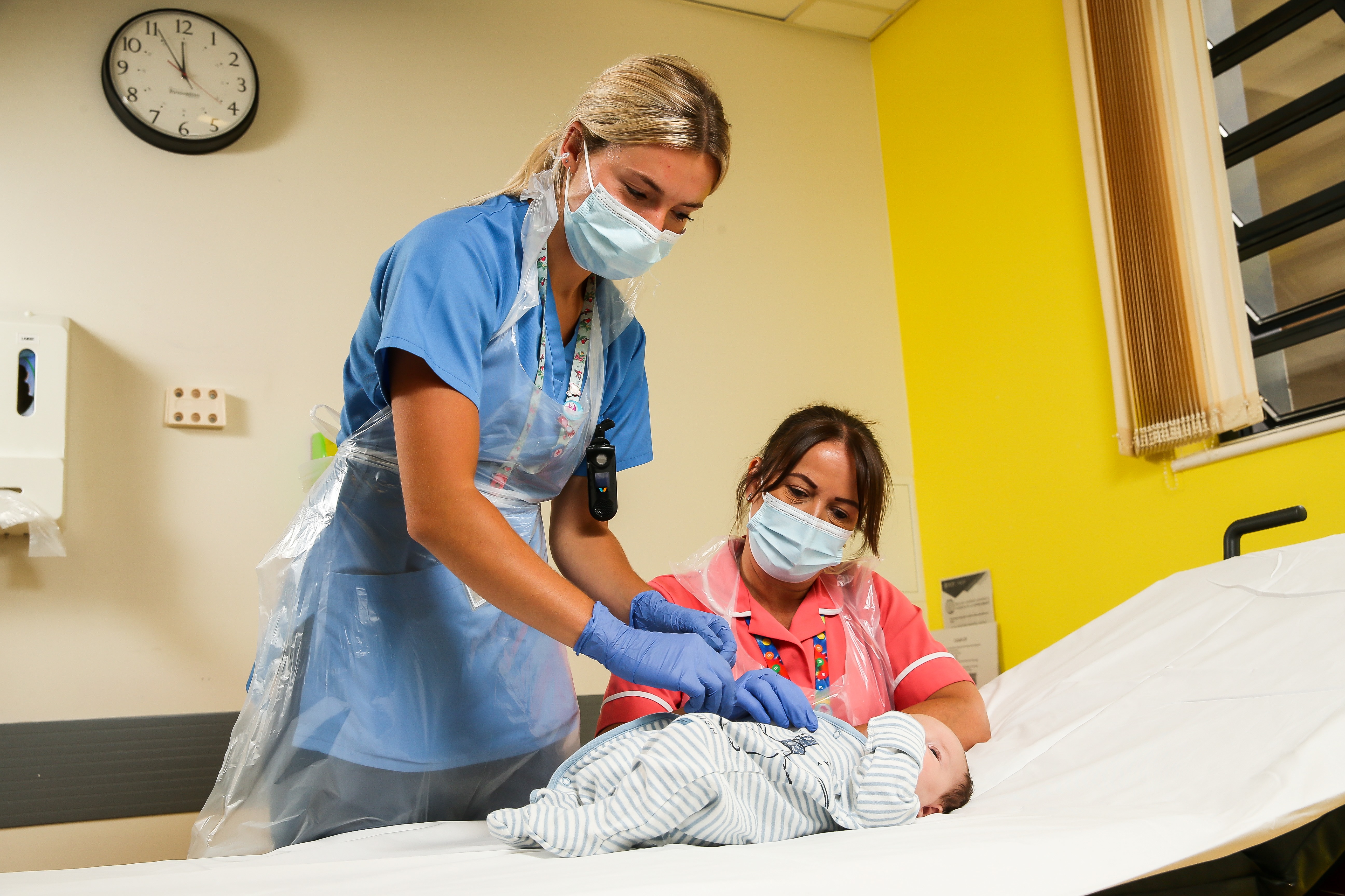 Two nurses with baby patient