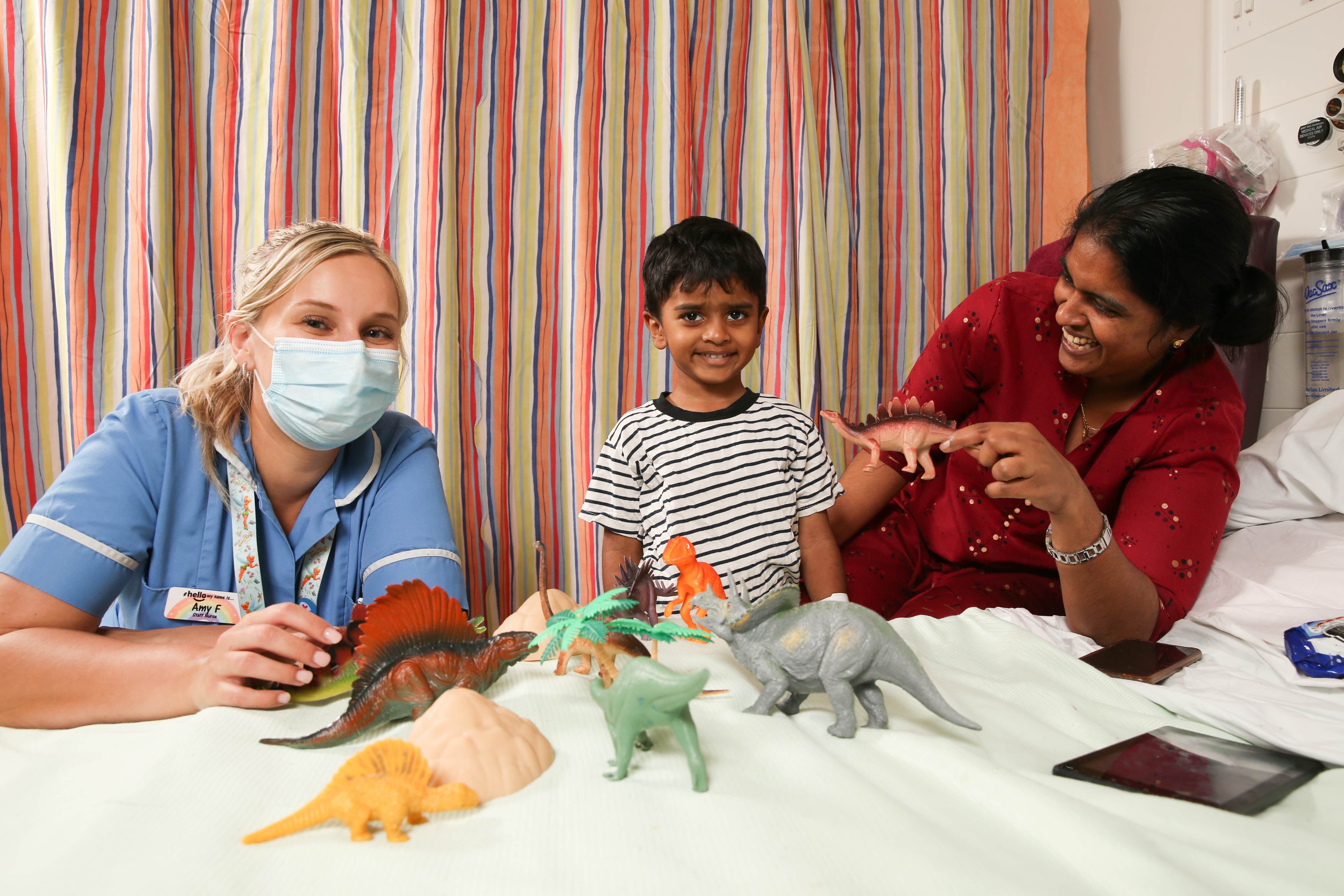 Staff nurse with patient and their mother