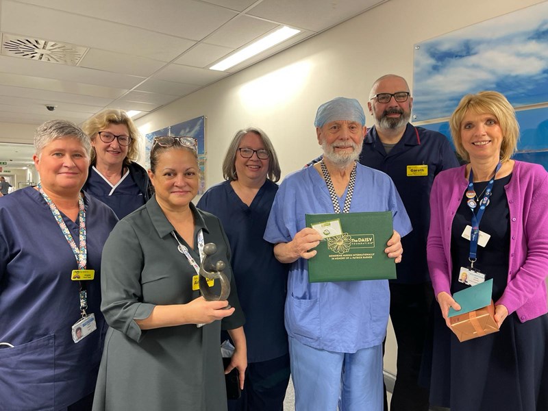 Eric Dray with his colleagues and daisy award