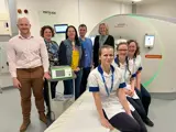 Imaging staff at UHNM in front of CT scanner